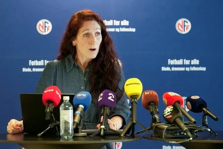 Speaker at press conference with microphones in front