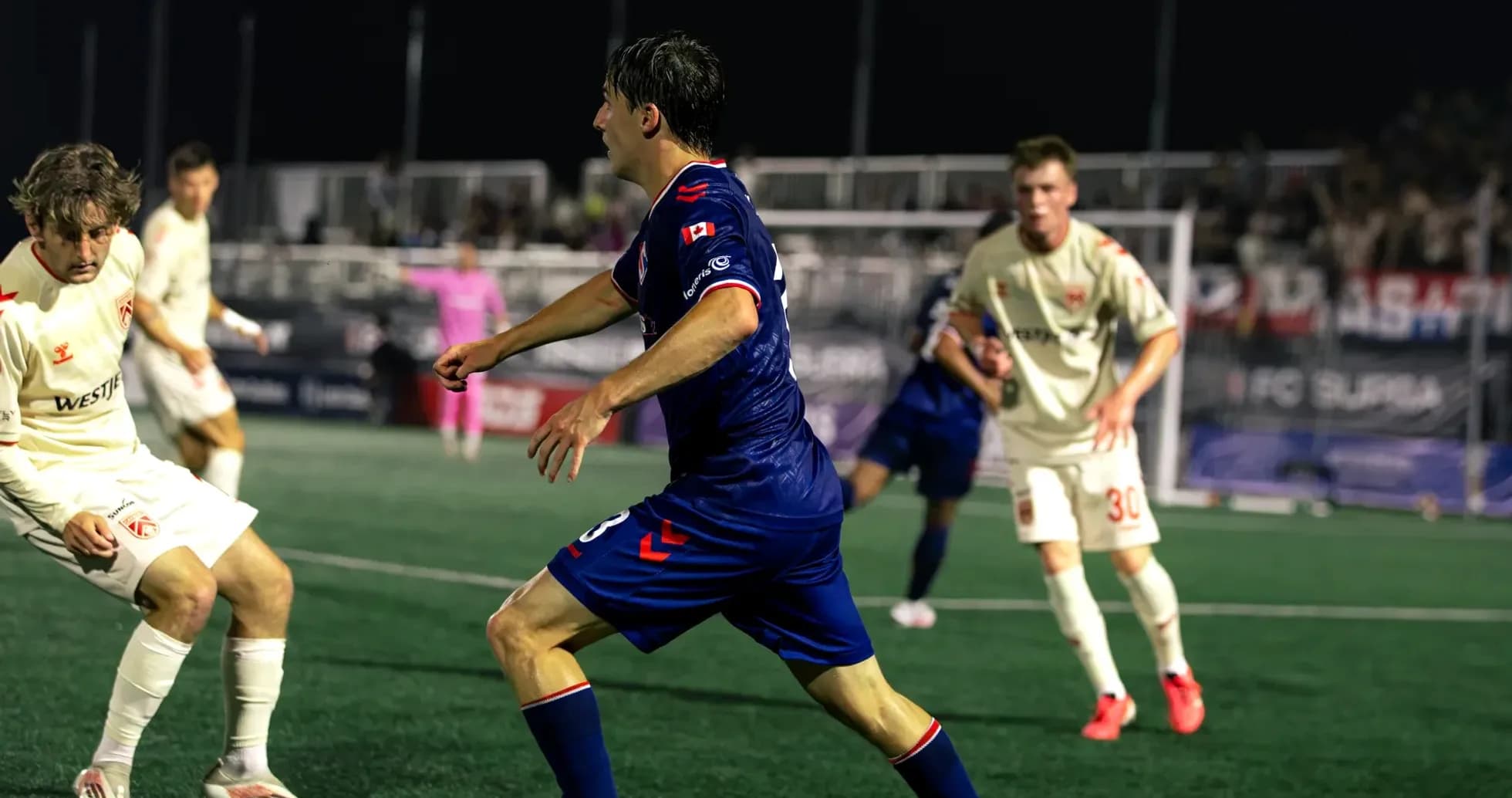 Cavalry FC player dribbling past opponents