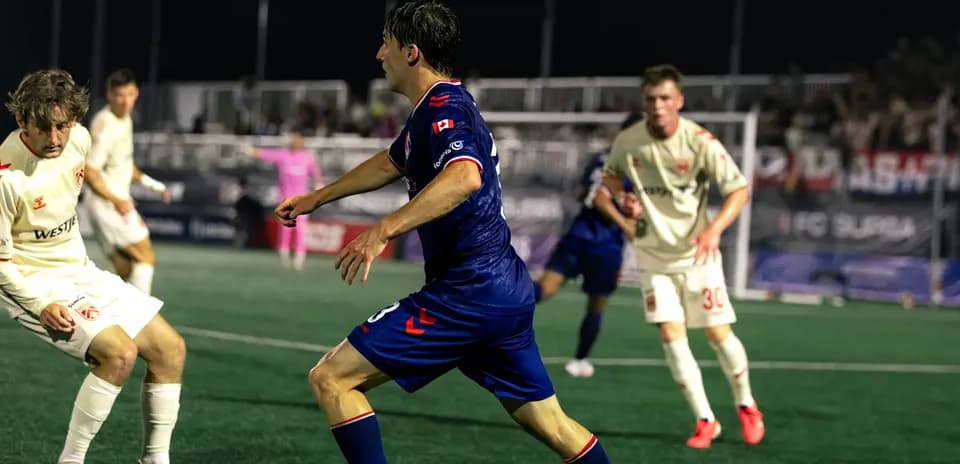 Cavalry FC player dribbling past opponents