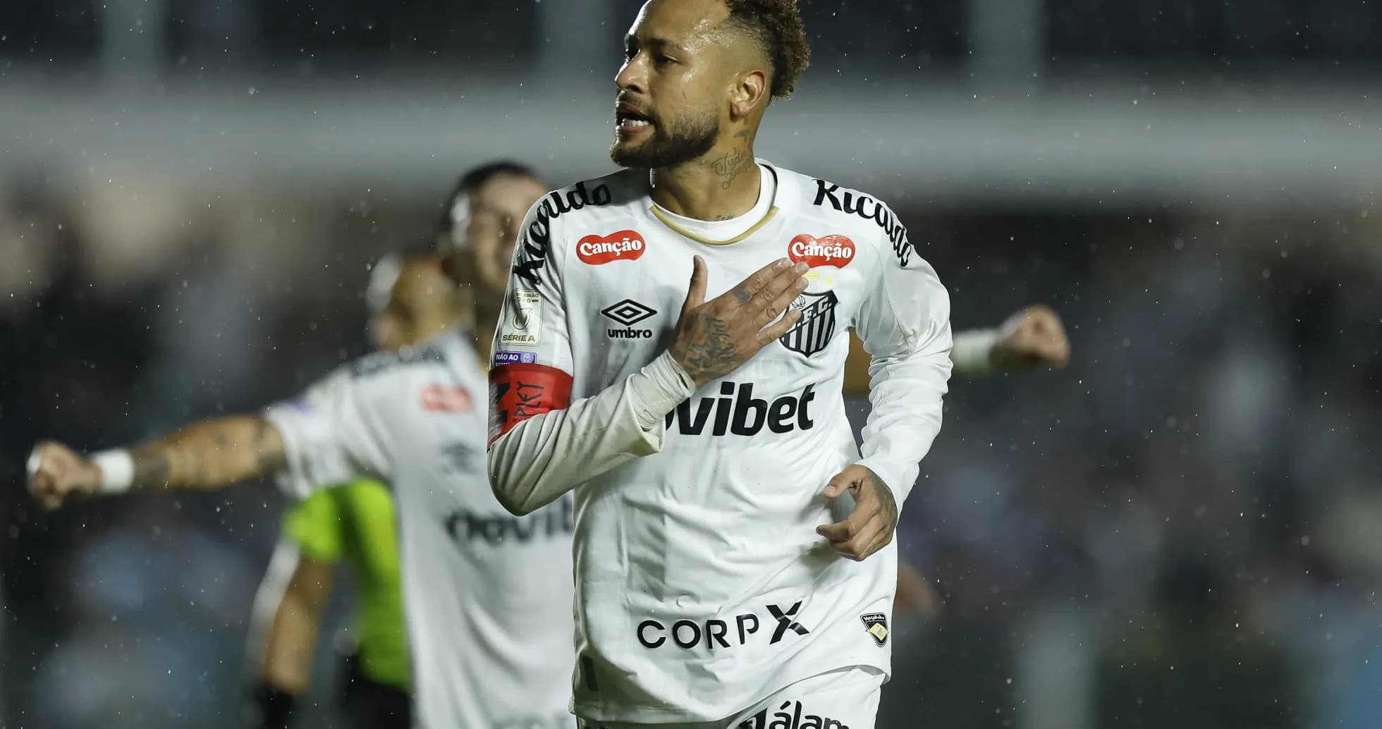 Neymar celebrating a goal for Santos FC in rain