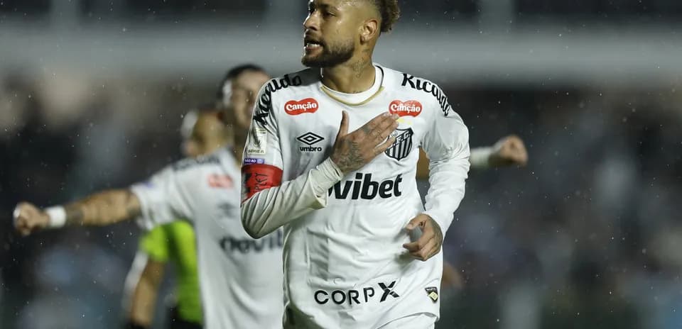 Neymar celebrating a goal for Santos FC in rain