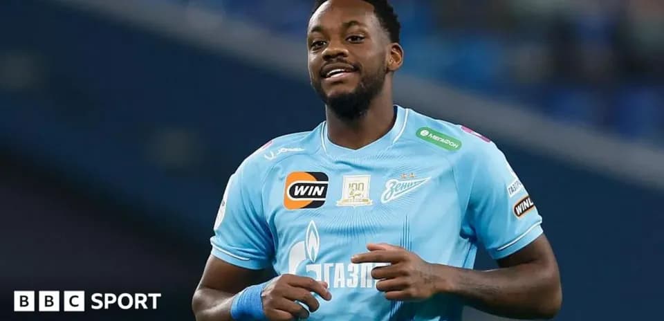 Player in blue jersey smiling during match