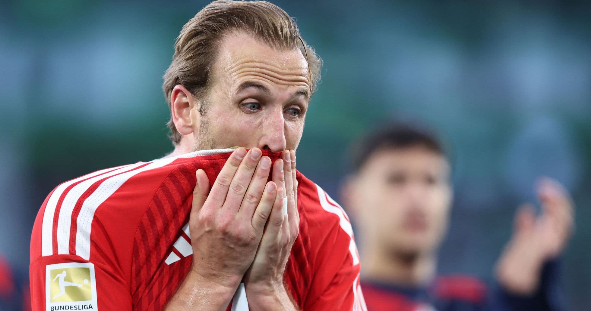 Player covering mouth with jersey during match