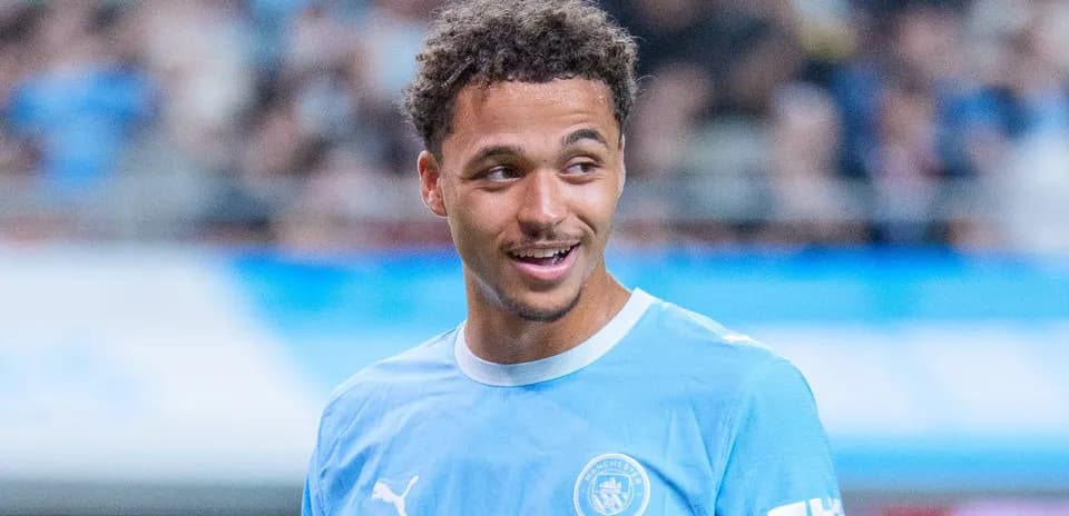Player smiling in Manchester City training kit