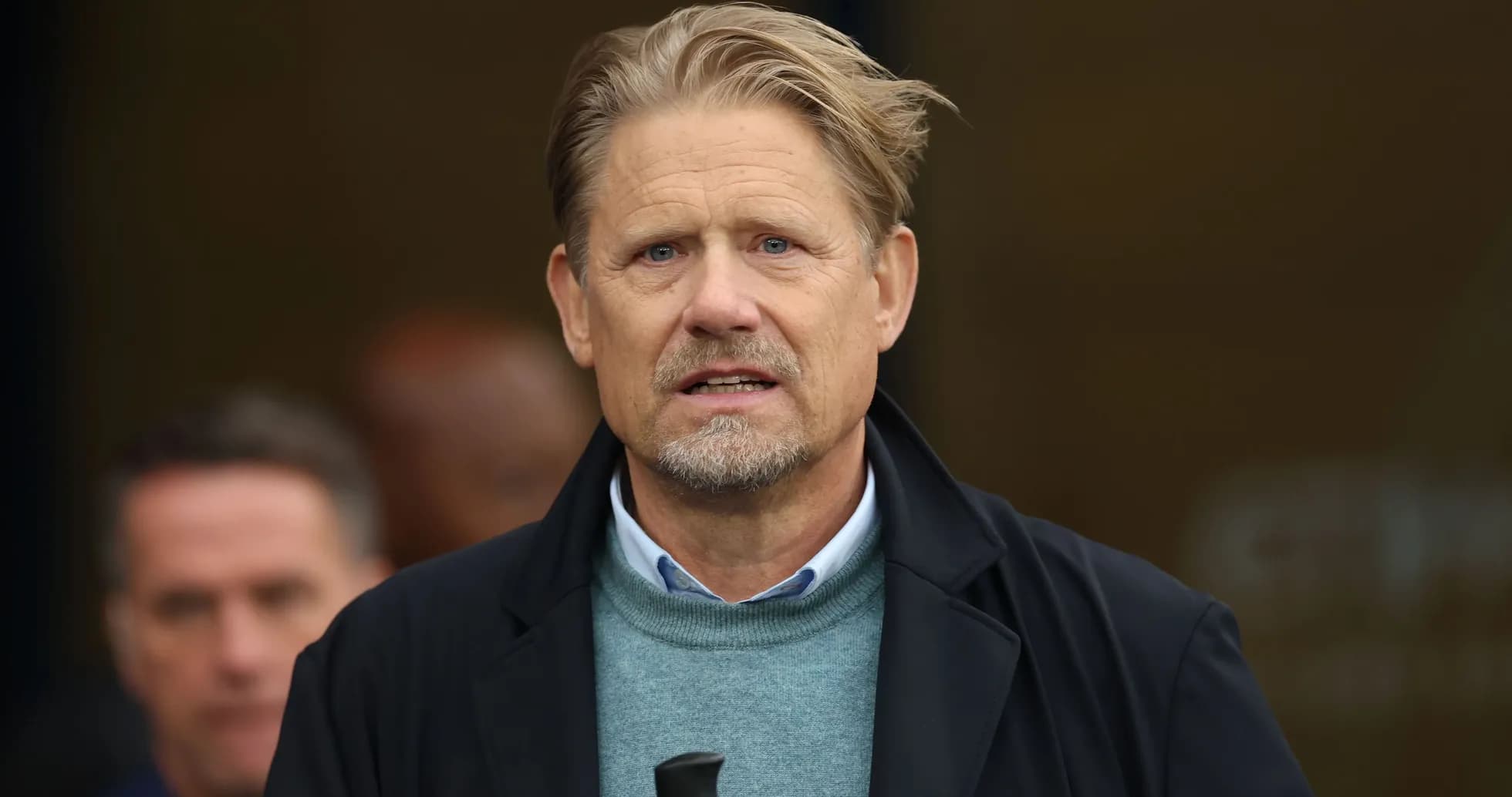 Man with blond hair speaking at event