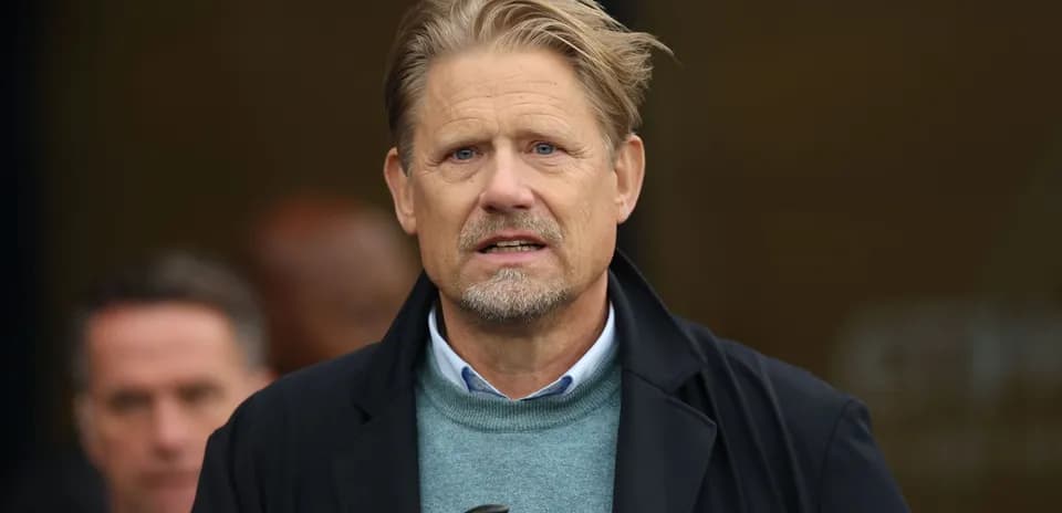 Man with blond hair speaking at event