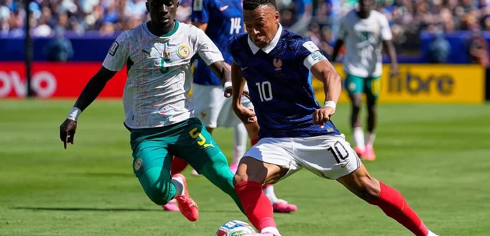 France player dribbling past Senegal defender