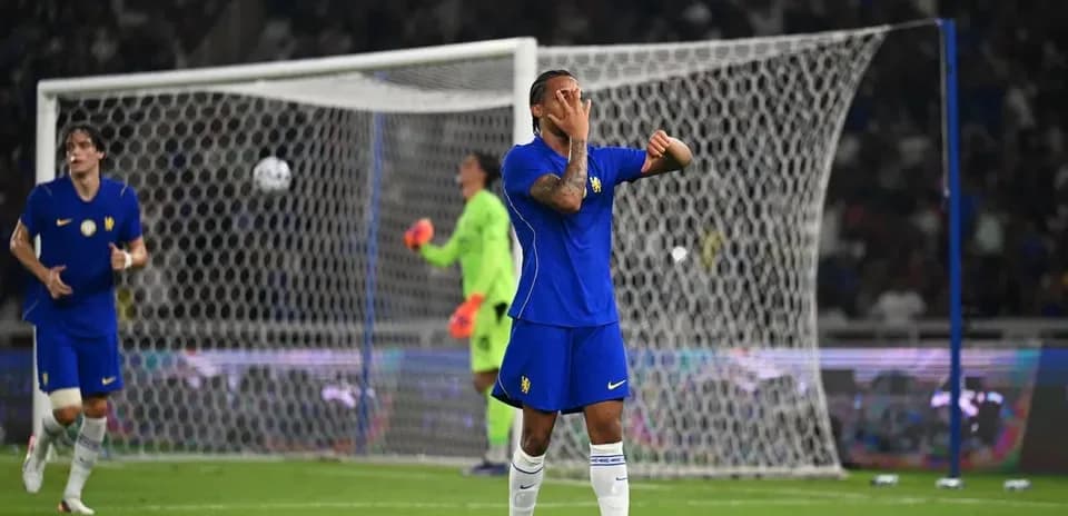 Player reacting during match with goal in background
