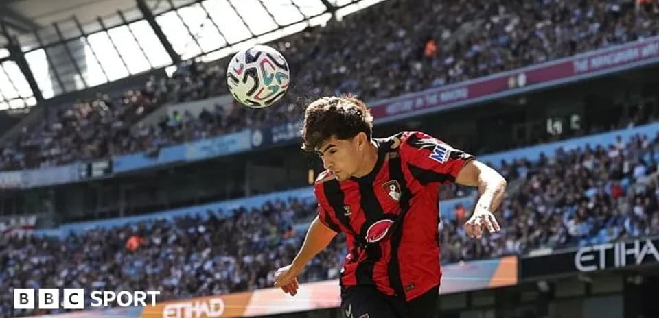 Bournemouth player heading ball during match at Etihad Stadium