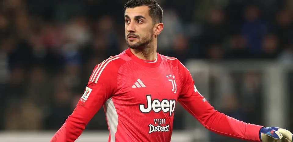 Goalkeeper in red jersey gesturing during match
