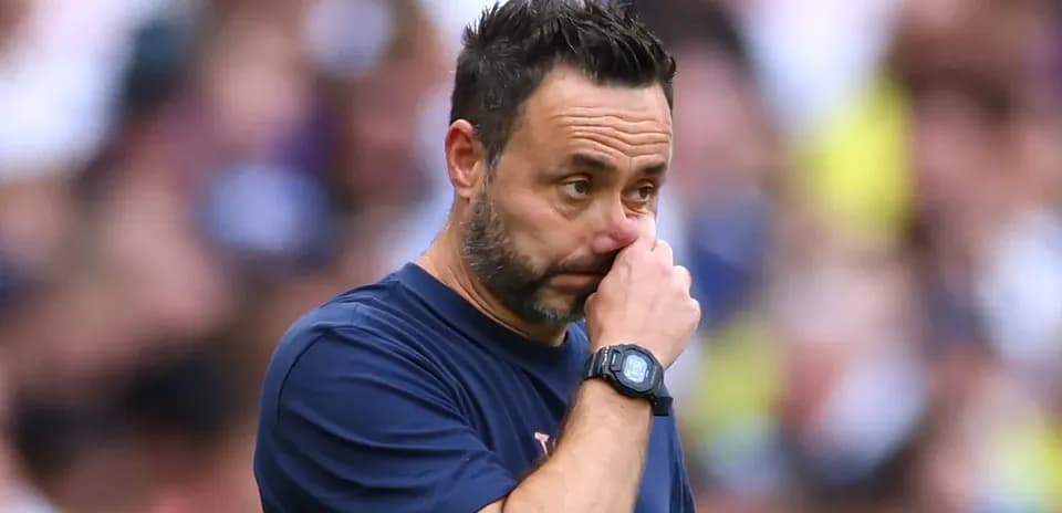 Coach contemplating during a match on the sidelines