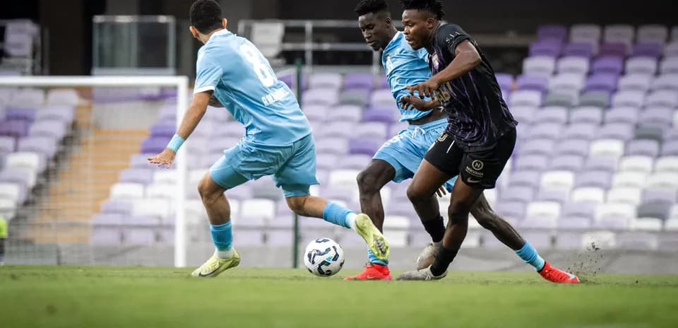 Two players competing for the ball in football match