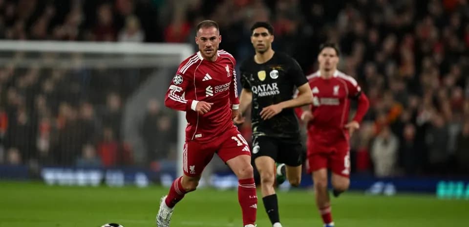 Liverpool player sprinting with ball during match