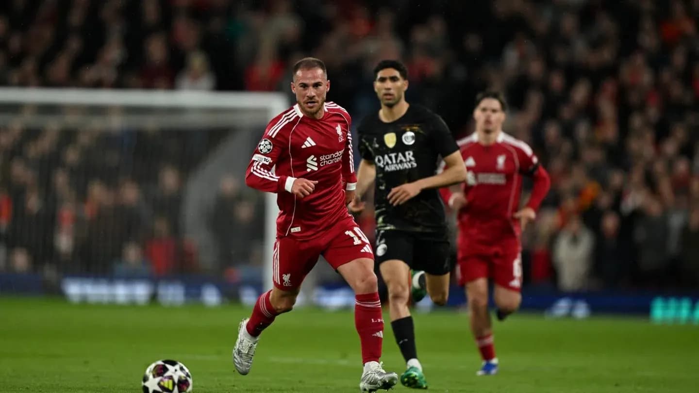 Liverpool player sprinting with ball during match