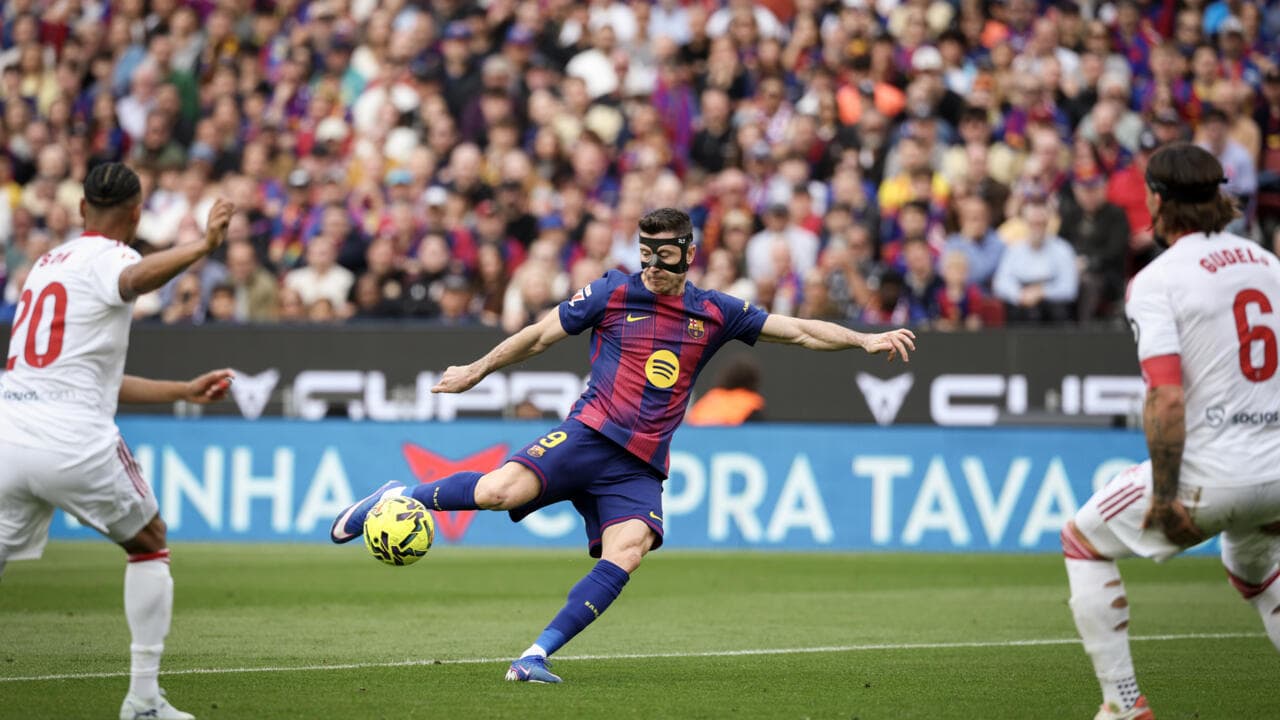 Player in mask striking the ball during match