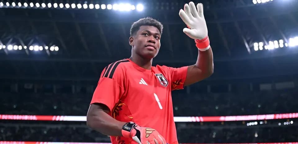 Goalkeeper waving while holding a banner