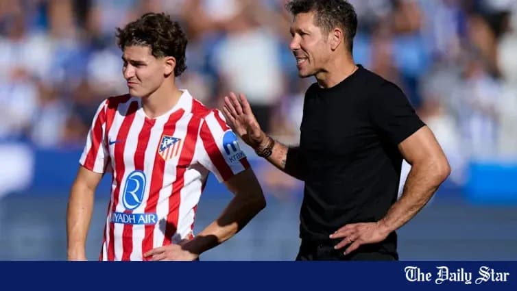 Atletico Madrid coach giving instructions to player