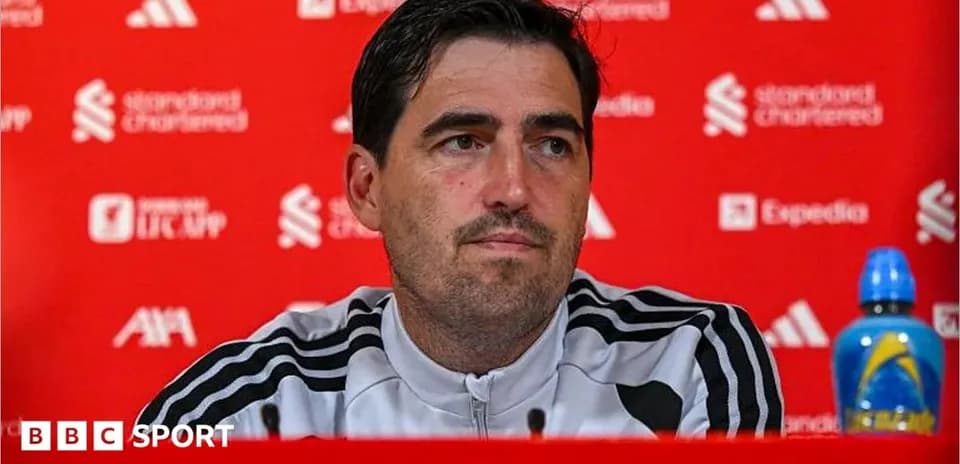 Manager at press conference with branded backdrop