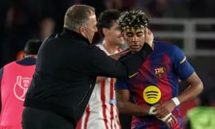 Coach interacting with Barcelona player on field