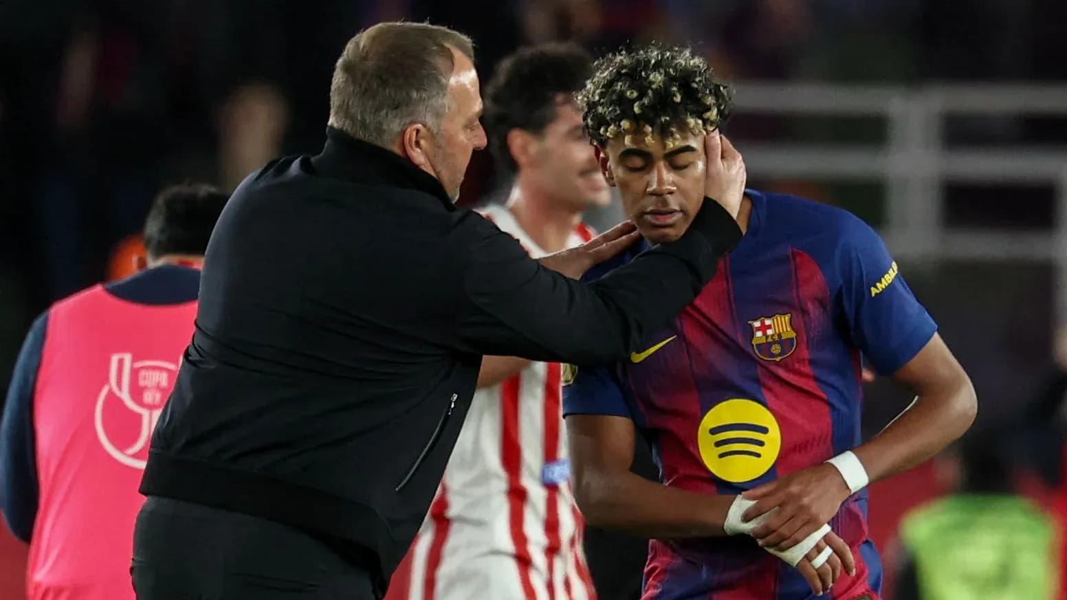 Coach interacting with Barcelona player on field