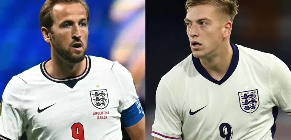 Two England players wearing white jerseys during match
