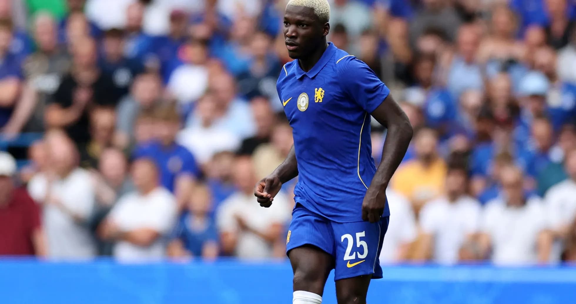 Player in blue jersey running on the pitch