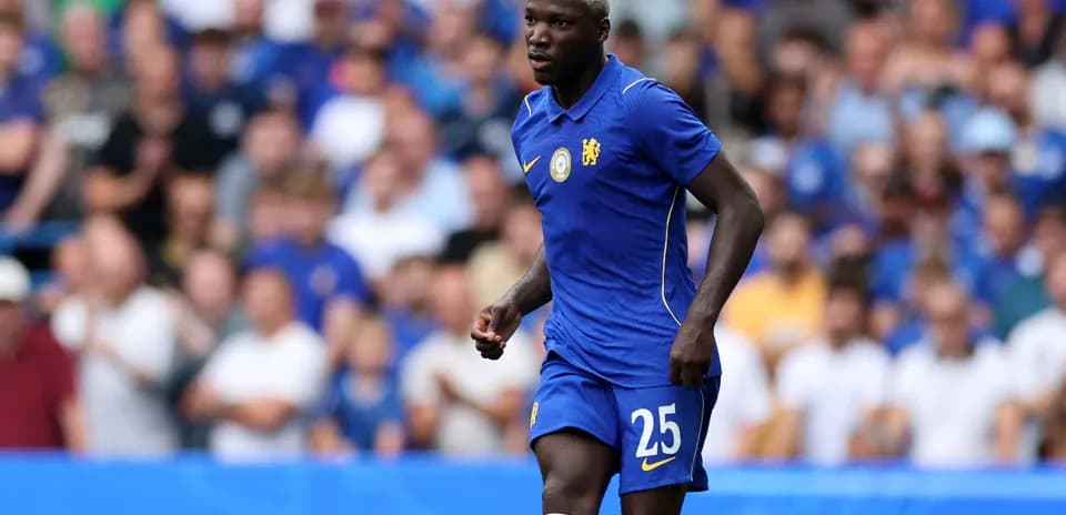 Player in blue jersey running on the pitch