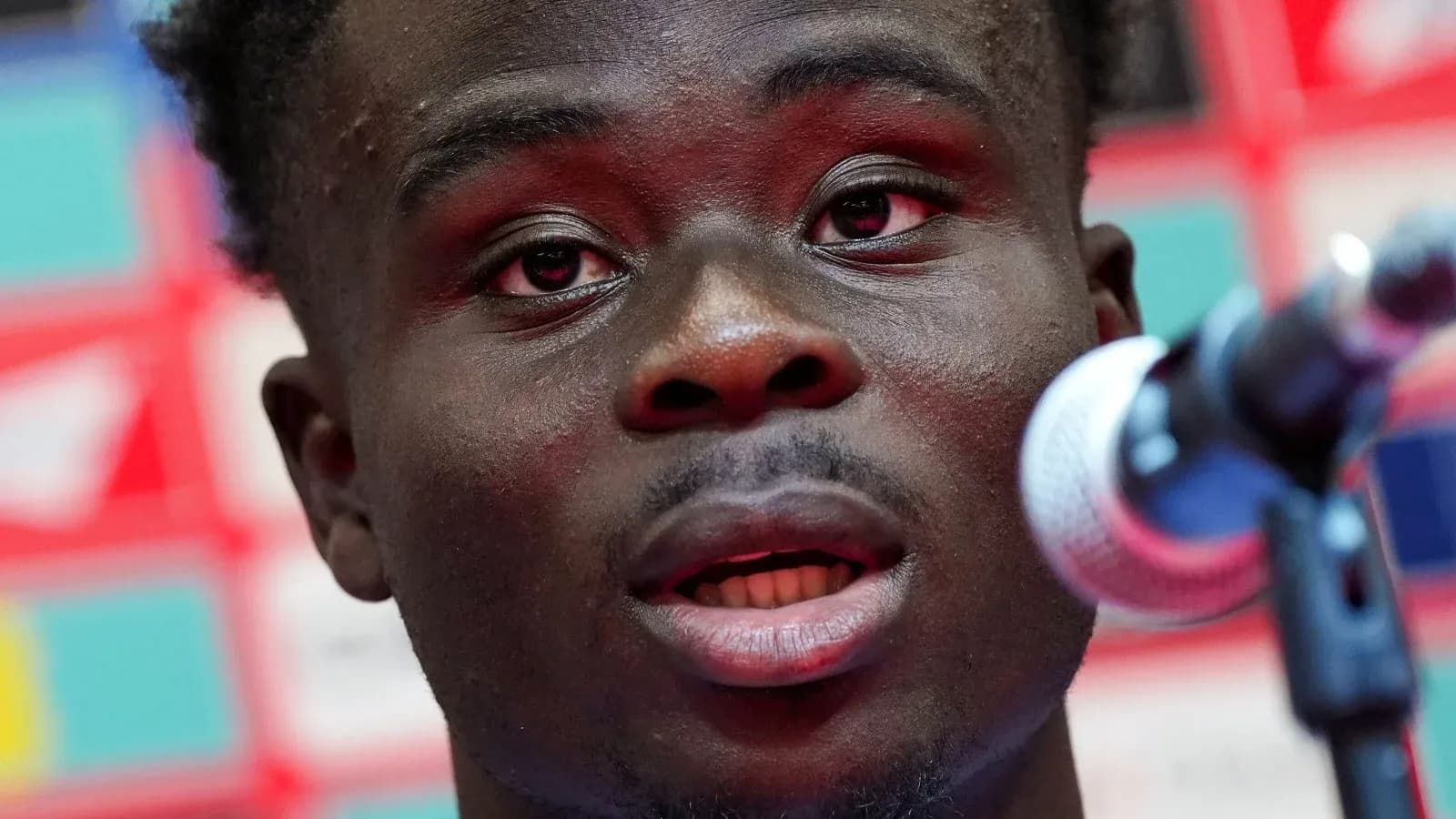 Player speaking at a press conference microphone