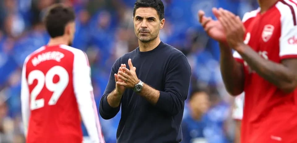 Manager clapping during match with players nearby