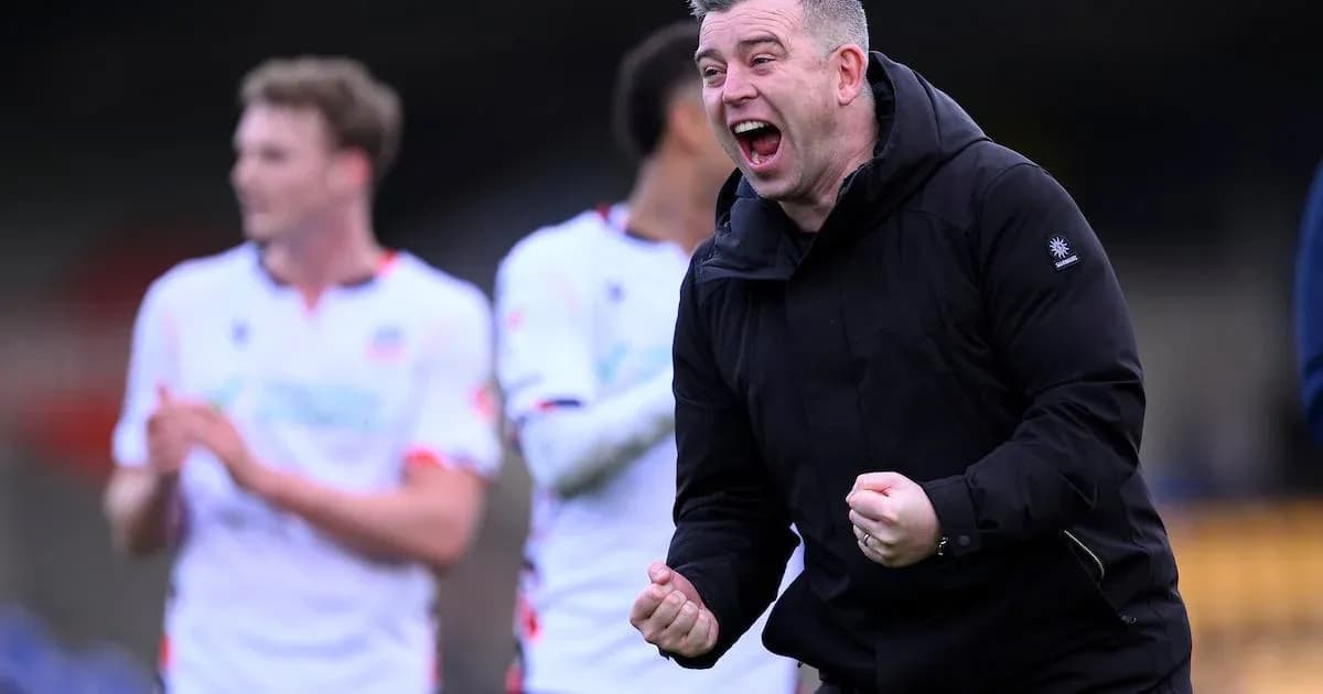 Coach celebrating victory with players in background