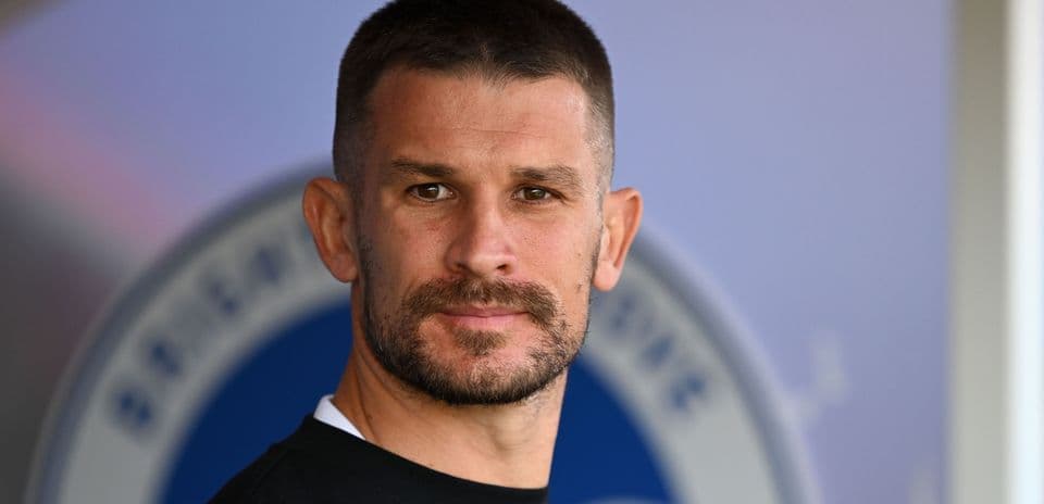 Player with short hair and beard posing for camera