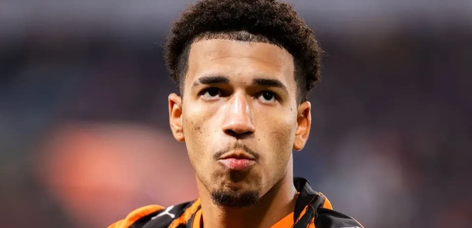 Player in orange jersey looking towards the camera