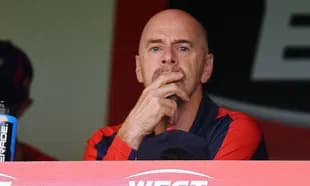 Coach observing the game from the dugout