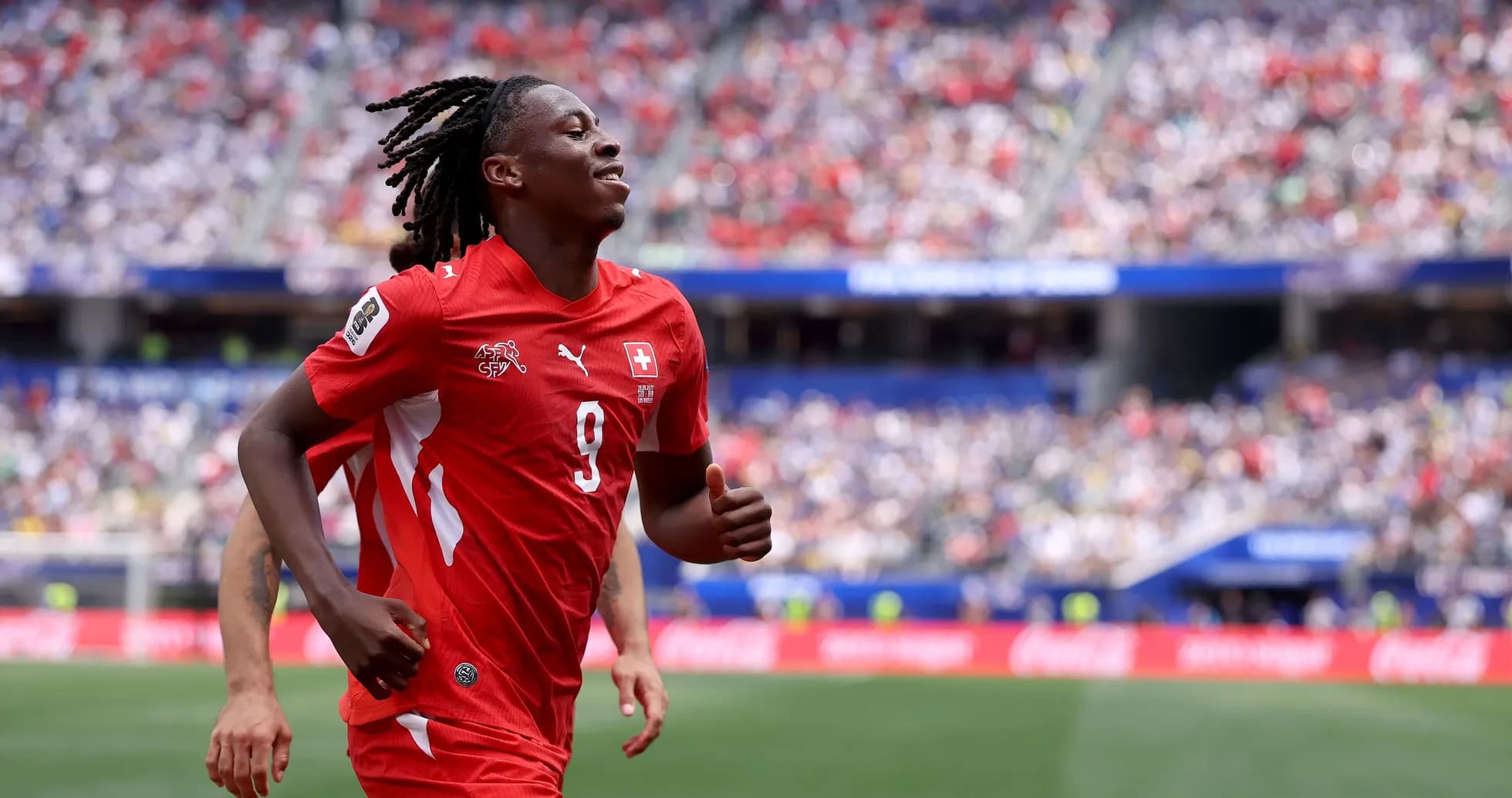Player in red jersey running on the field