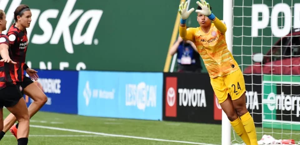 Goalkeeper saving a shot during match