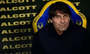 Coach seated on bench before match