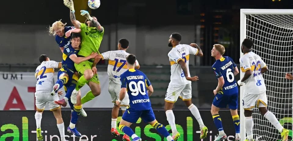 Goalkeeper challenges for the ball in match