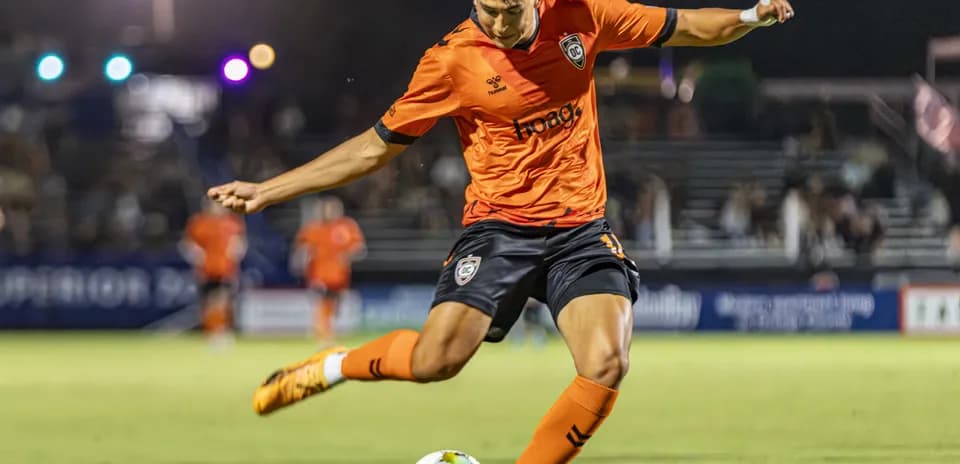 Player kicking ball during New Mexico United match