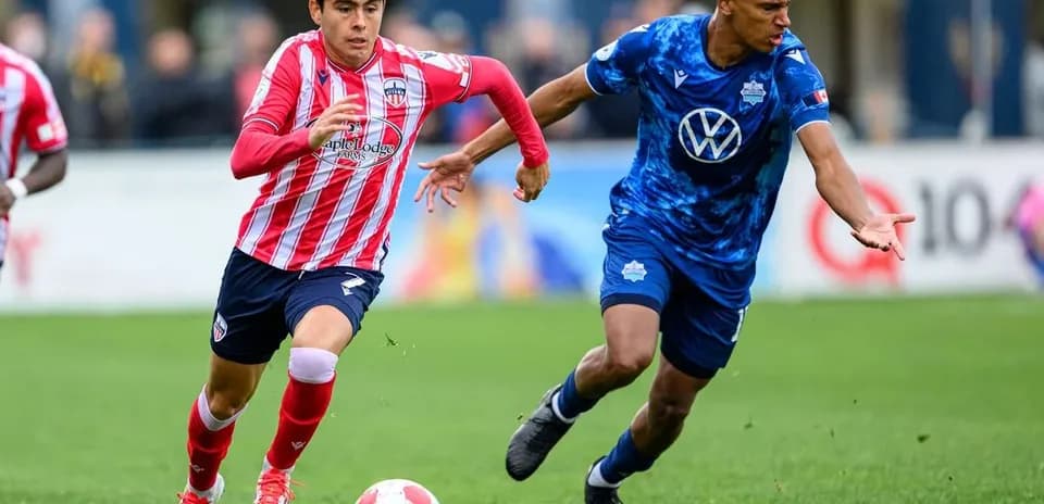 HFX Wanderers FC player dribbling past Atlético Ottawa opponent