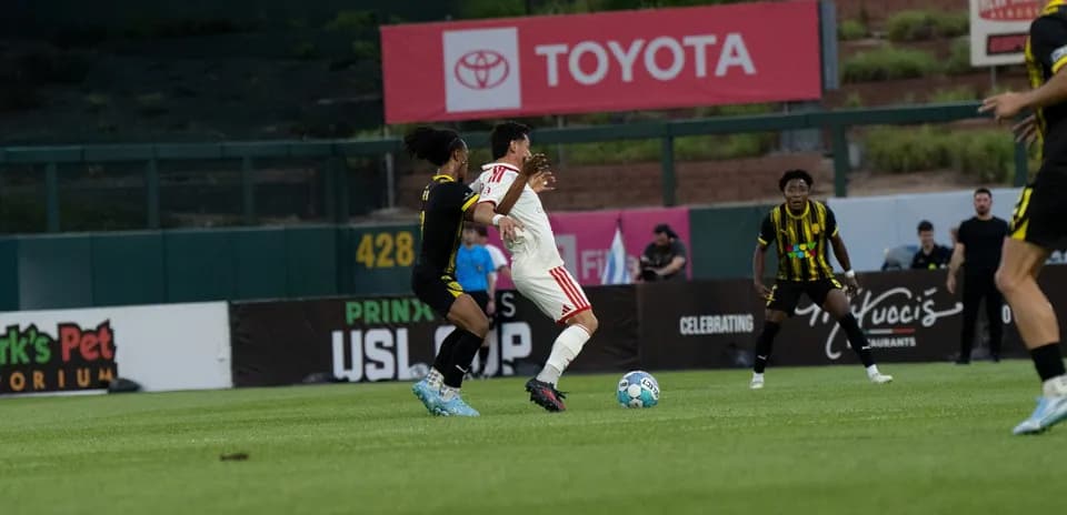 Players contesting the ball in USL match