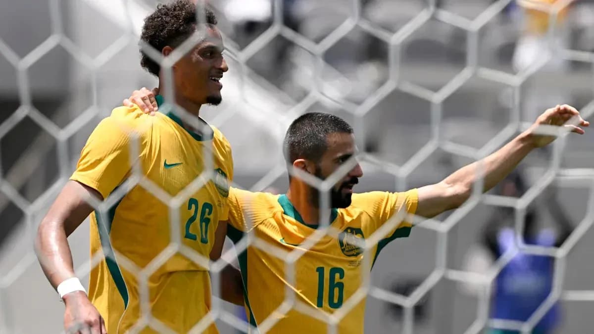 Two Australian players celebrating a goal together