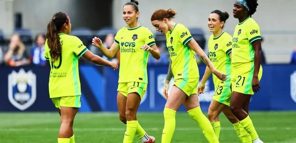Players celebrating during NWSL match