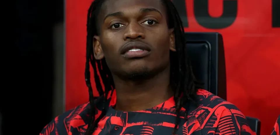 Player sitting on the bench in AC Milan kit