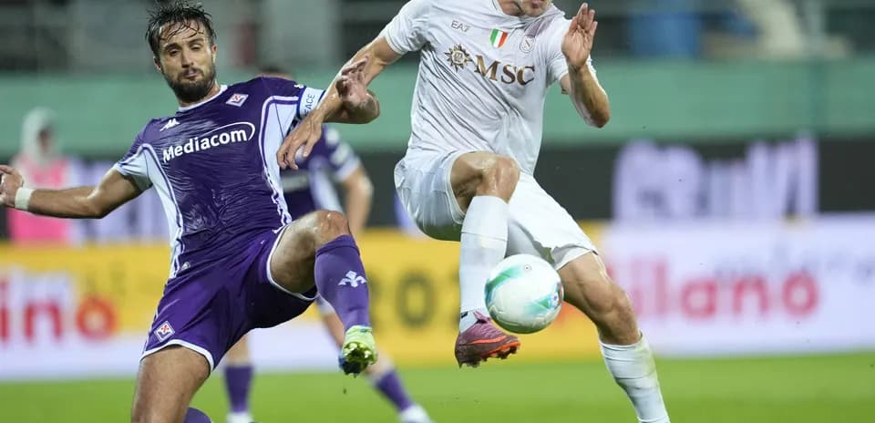 Fiorentina player tackling Napoli opponent during match