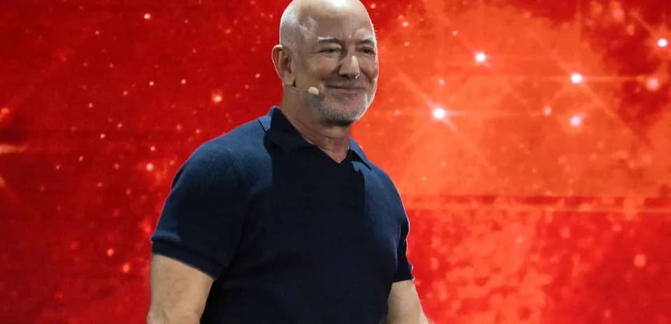 Speaker on stage with a red background