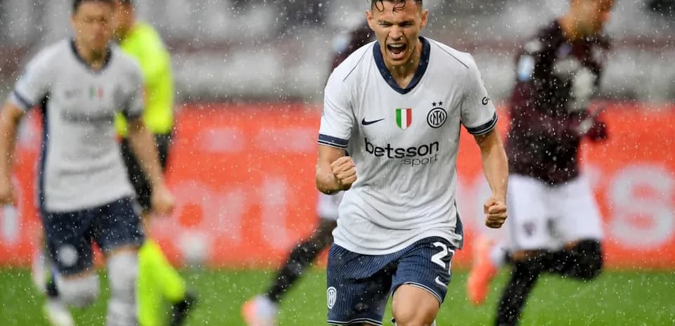 Inter player celebrating goal during rainy match