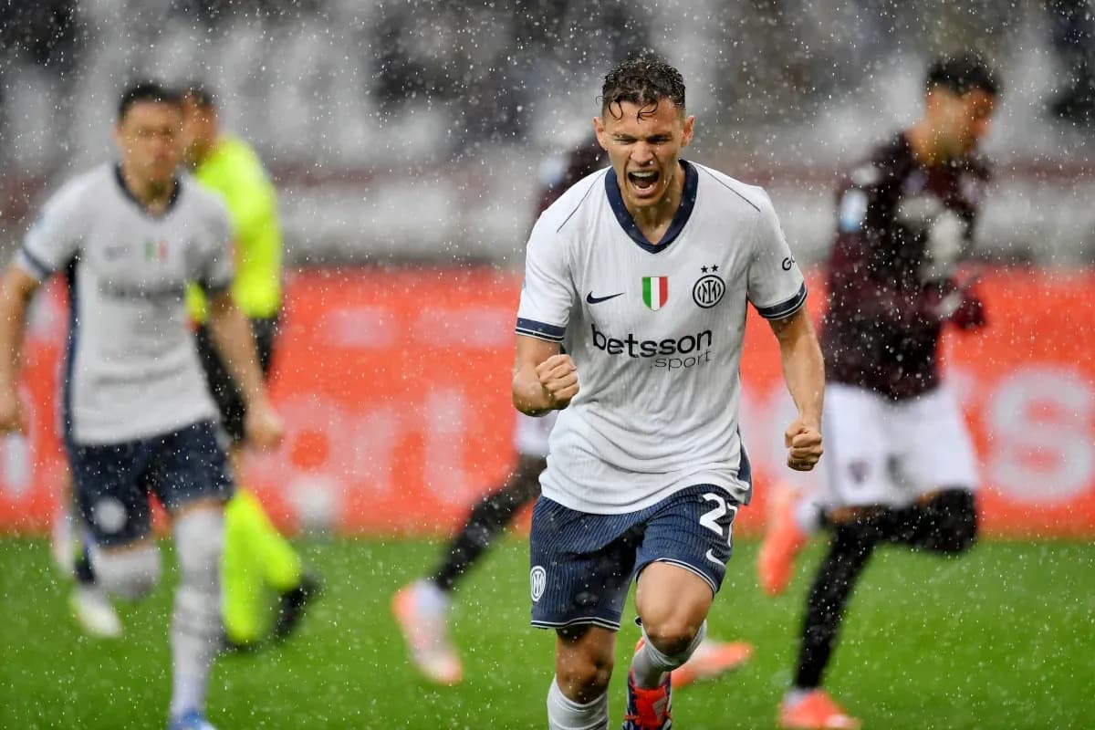 Inter player celebrating goal during rainy match