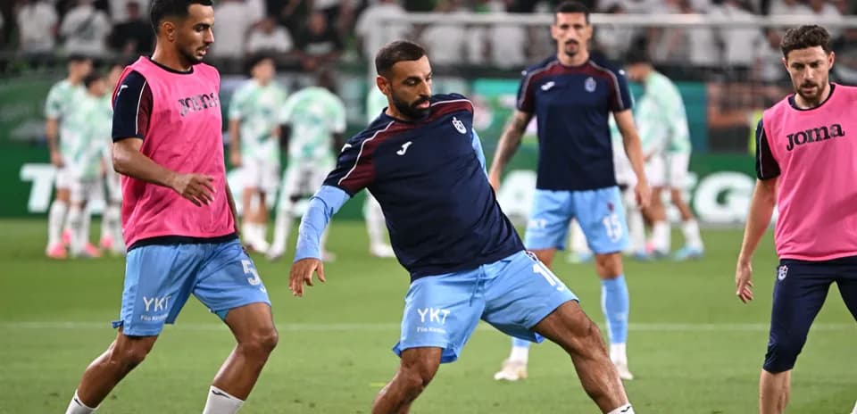 Players warming up on the pitch before match