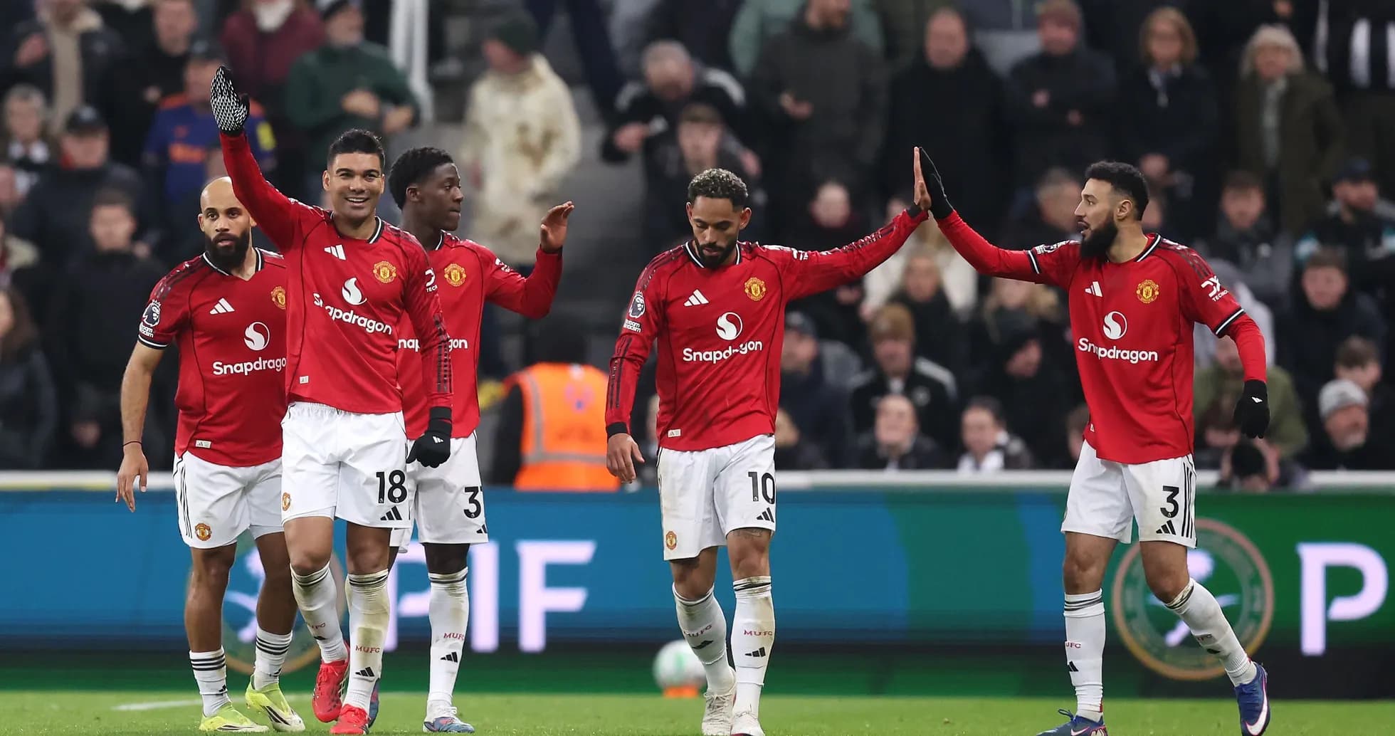 Manchester United players celebrating a goal on field