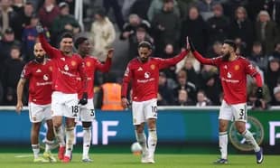 Manchester United players celebrating a goal on field